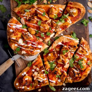 Chicken Tikka Pizza Recipe: Crispy Homemade Tandoori-Style Pizza 6 Flatbread pizzas topped with grilled chicken tikka, tomato sauce, coriander, sliced almonds, and a drizzle of white sauce.