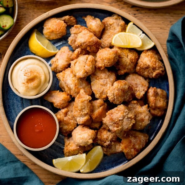 Crispy Chilli Beef in the Air Fryer: Quick Spicy Recipe 16 A plate of Air Fryer Chicken Karaage bites served with lemon wedges.