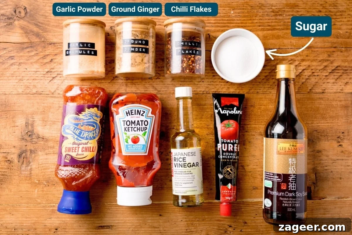 Crispy Chilli Beef in the Air Fryer: Quick Spicy Recipe 5 Ingredients for crispy chilli beef sauce on a wooden table including: tomato purée, sweet chilli sauce, soy sauce and ketchup.