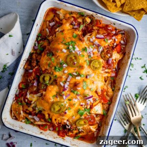Slow-Cooker Salsa Chicken Recipe for Flavor-Packed Weeknight Meals 7 A baked casserole dish filled with tender baked salsa chicken, topped with melted cheese, jalapeños, red onions, and chopped herbs; tortilla crisps sit in a bowl nearby.
