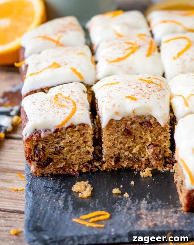 Carrot and Orange Tray Bake with Orange-Soaked Raisins 4 close up of a fluffy moist carrot tray bake with orange infused raisins and zesty cream cheese frosting