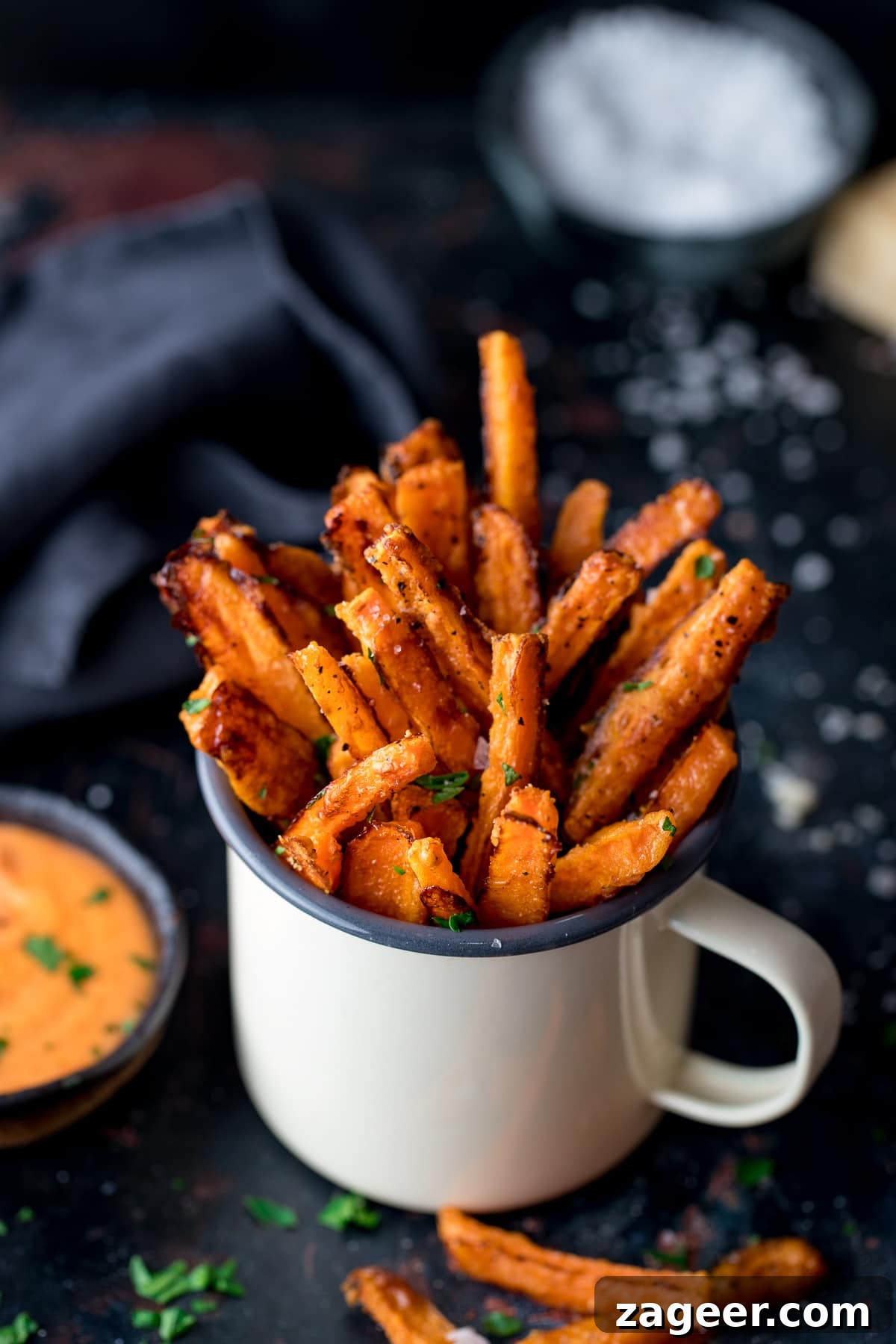 Crispy Baked Parmesan Carrot Fries Recipe 7 Carrot fries in a white enamel mug