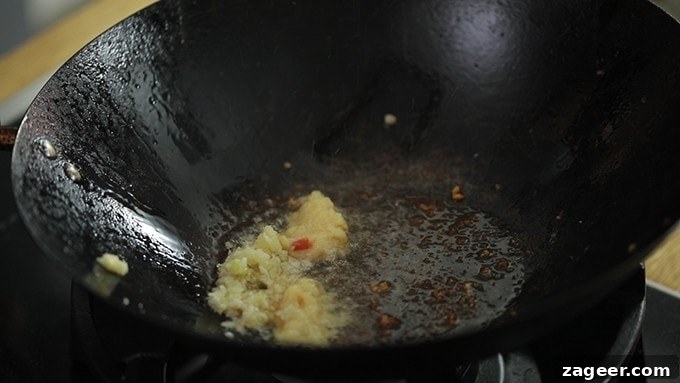 garlic and ginger frying in a wok