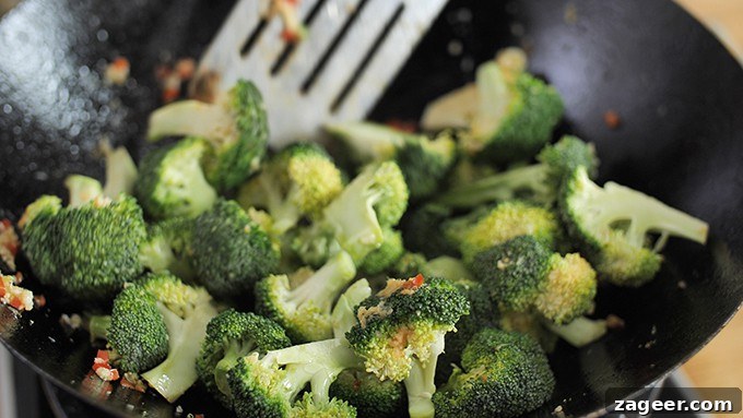 close up of broccoli frying in a wok