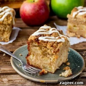 15 Cozy Autumn Baking Ideas for Weekend Treats 15 Slice of apple streusel cake with vanilla icing.