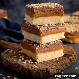 15 Cozy Autumn Baking Ideas for Weekend Treats 5 3 pieces of salted caramel millionaire's shortbread piled on a rustic wooden board.