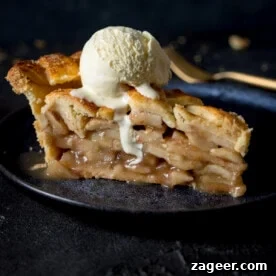 15 Cozy Autumn Baking Ideas for Weekend Treats 7 A grey plate with a slice of deep dish apple pie with a scoop of vanilla ice cream.