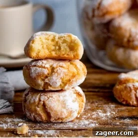 15 Cozy Autumn Baking Ideas for Weekend Treats 9 Italian Amaretti cookies in a pile on a wooden board.