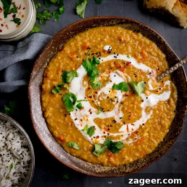 Homemade Thai Yellow Curry with Fish Recipe 8 A bowl of red lentil dahl garnished with cream and coriander.