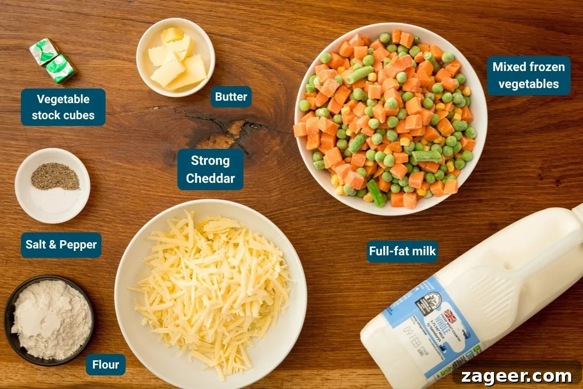 Cheddar and Vegetable Chowder Recipe with Creamy Veggies 4 Ingredients for a cheese and Vegetable Chowder laid out on a wooden surface: mixed frozen vegetables, mature cheddar, whole milk, flour, butter, vegetable stock cubes, salt, and pepper.