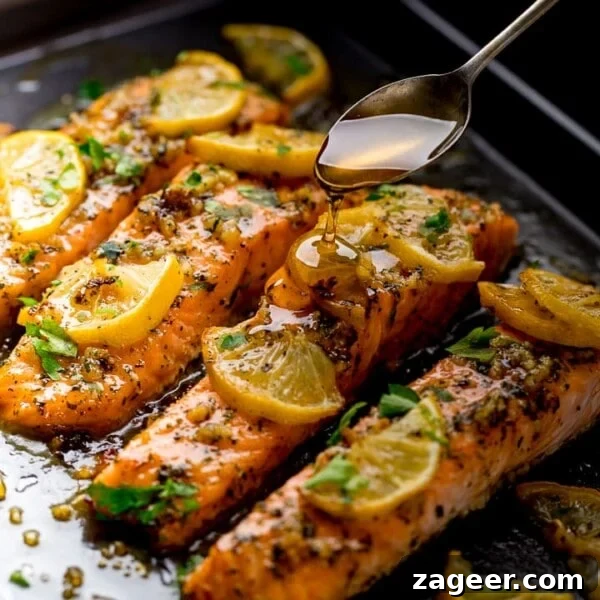 Steak Fries with Creamy Peppercorn Sauce 12 Baked salmon on a tray topped with lemon slices. Honey being drizzled on top with a spoon.