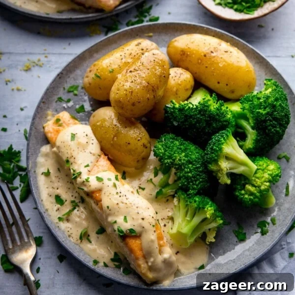 Tuscan Salmon with Creamy Lemon Orzo Recipe 10 Salmon on a grey plate with creamy white wine sauce, broccoli and new potatoes