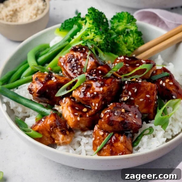 Tuscan Salmon with Creamy Lemon Orzo Recipe 13 Air Fryer Teriyaki Salmon served on white rice, with broccoli, topped with sesame seeds and spring onions.