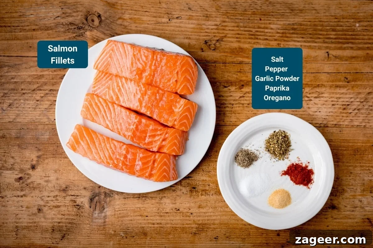 Tuscan Salmon with Creamy Lemon Orzo Recipe 4 Four raw salmon fillets on a white plate sit next to a small white plate with seasonings on —salt, pepper, garlic powder, paprika, and oregano. The plates are on a wooden surface.