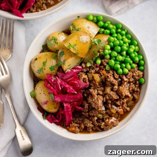 Crispy Potato and Bacon Hash Recipe for Breakfast or Brunch 7 A bowl of savoury minced beef in gravy with, boiled new potatoes, peas, and red cabbage, topped with fresh parsley.