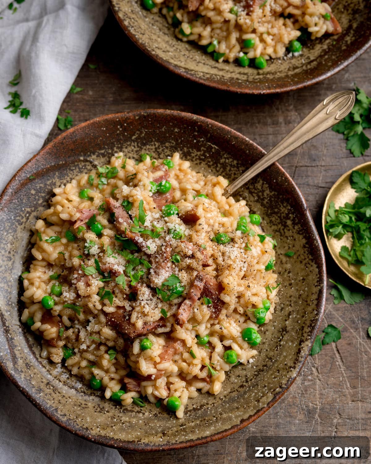 Creamy Ham and Spring Pea Risotto Recipe 5 Ham and Pea Risotto served in a rustic brown bowl with a fork sticking out.