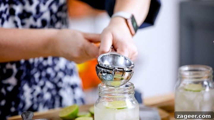 Dark ’N’ Stormy Cocktail Recipe: Classic Rum & Ginger Mix 4 Squeezing lime into a mason jar for a cocktail