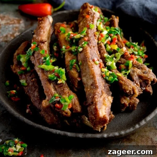 Sticky Slow-Cooked BBQ Ribs You Can Make at Home 7 Salt and pepper pork ribs on a black plate