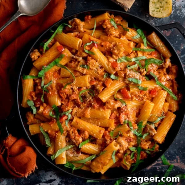 Spicy Gochujang Cream Pasta Recipe You’ll Love 13 Overhead photo of a black frying pan full of spicy sausage rigatoni.