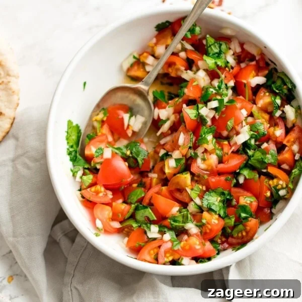 Crisp Asian Cucumber Salad with Sesame Ginger Dressing 7 tomato, onion and coriander chopped salad in a white bowl