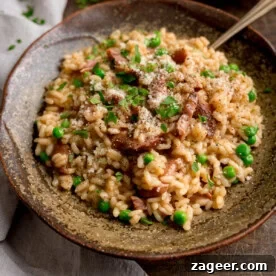11 Fresh Spring Dinners Ready in 30 Minutes or Less 7 Square image of Ham and Pea Risotto served in a rustic brown bowl. There is a fork sticking out.