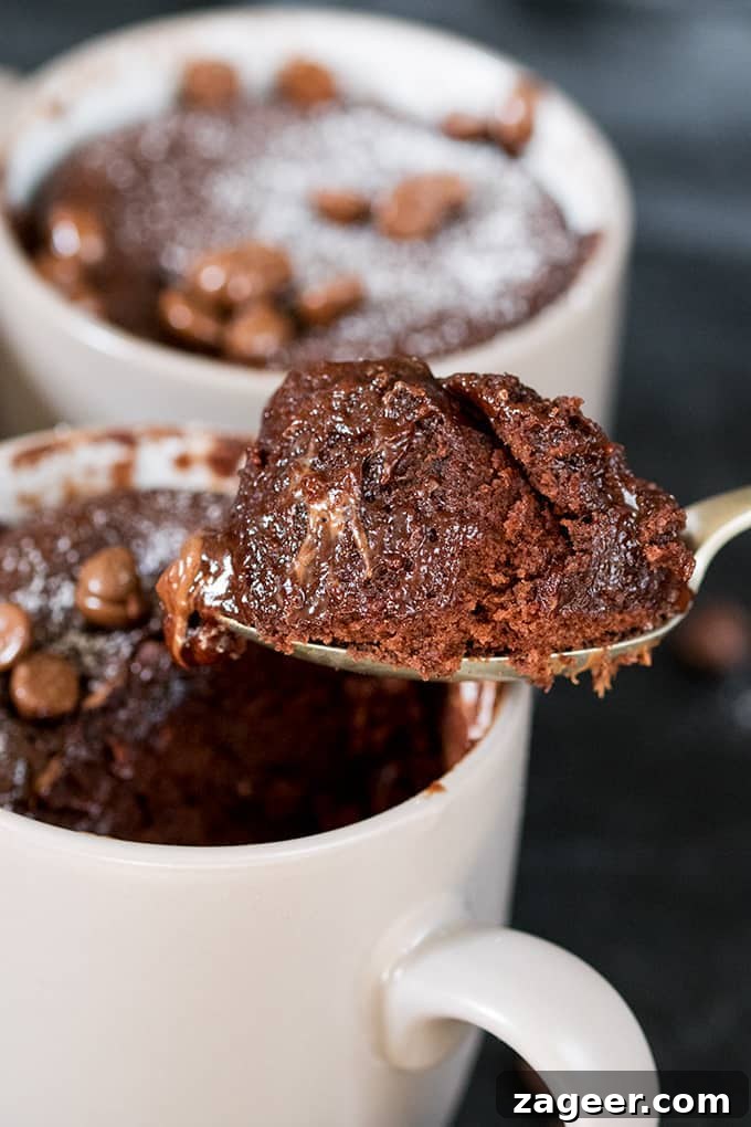Quick Chocolate Caramel Mug Cake Recipe for One 2 Close up of Chocolate Caramel Mug Cake on a spoon with the mug in the background
