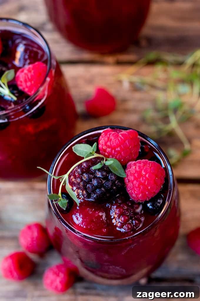 Sparkling Rum Berry Cocktail for New Year's Eve Celebration 2 New Year's Eve Rum Berry Cocktail! With rum, Cointreau, pomegranate juice and ginger beer! Use frozen berries instead of ice cubes to finish the look!