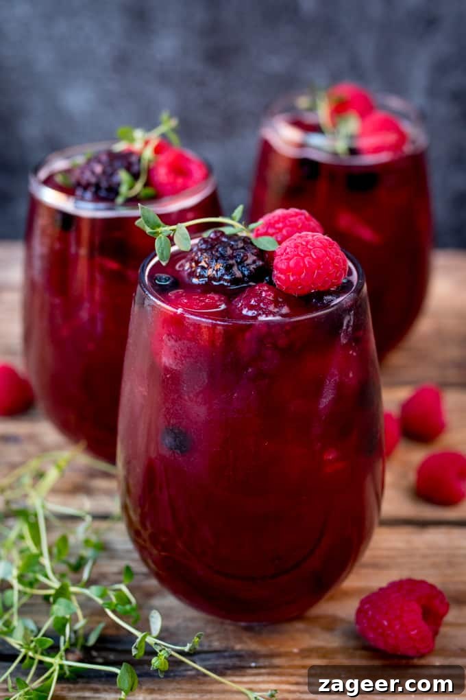 Sparkling Rum Berry Cocktail for New Year's Eve Celebration 3 New Year's Eve Rum Berry Cocktail! With rum, Cointreau, pomegranate juice and ginger beer! Use frozen berries instead of ice cubes to finish the look!