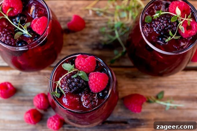 Sparkling Rum Berry Cocktail for New Year's Eve Celebration 4 New Year's Eve Rum Berry Cocktail! With rum, Cointreau, pomegranate juice and ginger beer! Use frozen berries instead of ice cubes to finish the look!