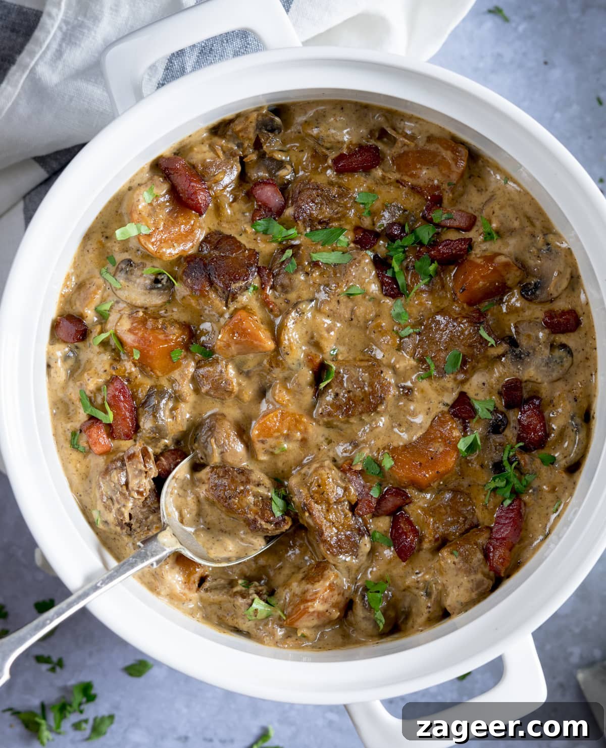 Creamy Slow-Cooked Pork Casserole Recipe for Comforting Dinners 5 Overhead image of creamy slow-cooked pork casserole in a white casserole dish on a light blue background.