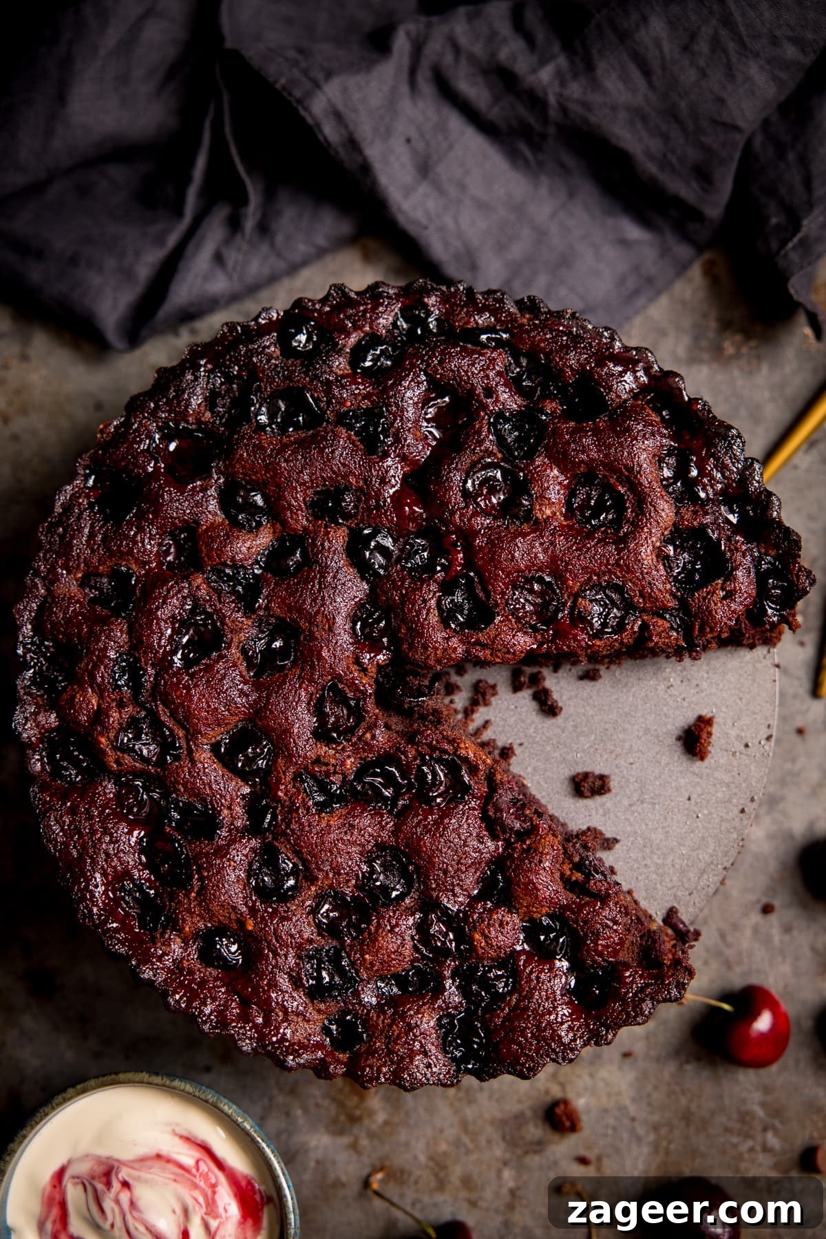 Decadent Chocolate Cherry Layer Cake Recipe 7 Overhead of Chocolate Cherry Cake with a slice taken out.
