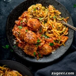 One-Pot Turkey Meatballs with Zucchini Noodles (Courgetti) 13 Square image of Turkey meatballs and courgetti on a dark plate