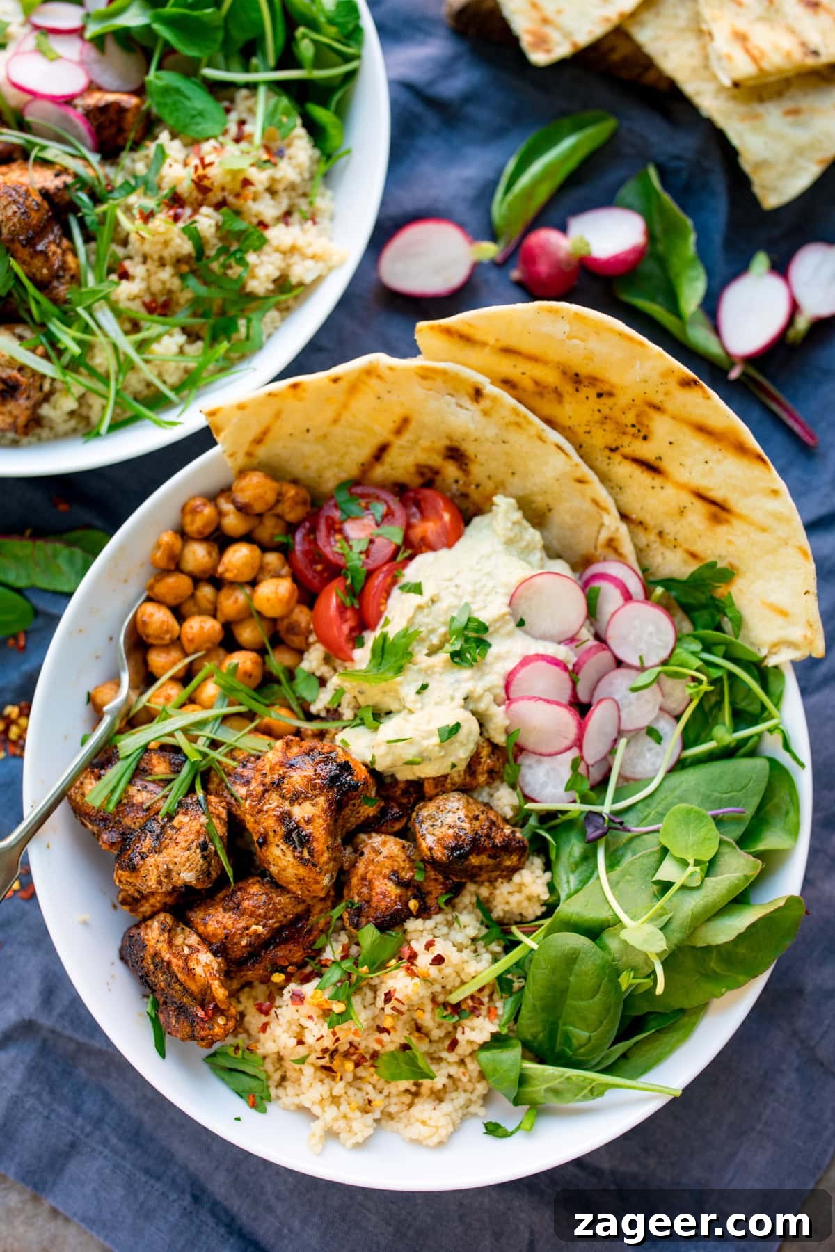 Spicy Chicken Power Bowl with Avocado & Lime Rice 5 spicy chicken, chickpeas, couscous, leaves, radish, hummus and flatbreads in a bowl