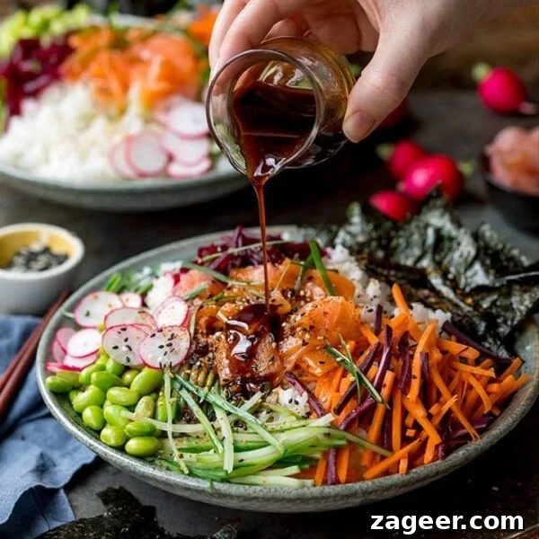 Spicy Chicken Power Bowl with Avocado & Lime Rice 7 Pouring soy dressing on a sushi salmon bowl