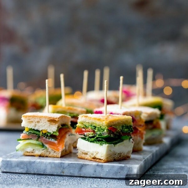 Chicken Chorizo Puff Pastry Rolls: Savory Baked Appetizer Recipe 14 Pressed mini sandwich bites with different fillings on a marble platter