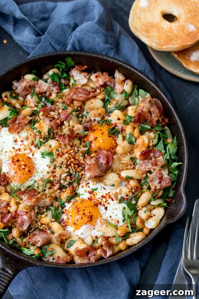 Spicy Scrambled Eggs with Smashed Beans Breakfast Bowl 5 Overhead picture of Spicy Egg Breakfast with Smashed Beans and Pancetta in a skillet