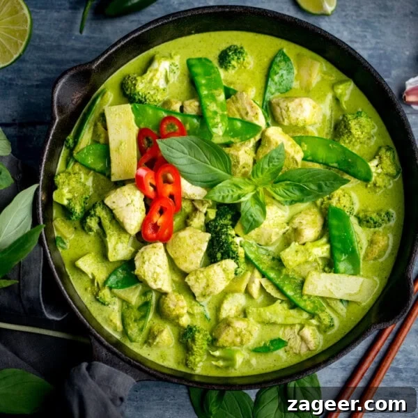 Creamy Seafood Laksa Recipe: Authentic Malaysian Coconut Noodle Soup 11 A bowl of Thai Green Curry with chicken, broccoli, mangetout, bamboo shoots, red chilli slices, and fresh basil leaves in a fragrant Thai green curry sauce.