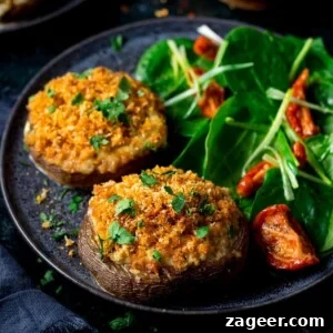 Cheesy Garlic Stuffed Mushrooms Recipe for Entertaining 5 Square image of Stuffed mushrooms on a black plate with salad