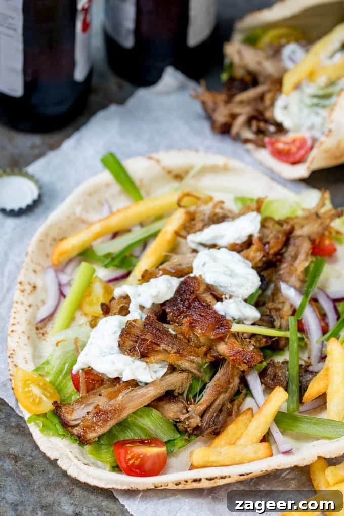 Crispy Pork Gyros Recipe: Greek-Style Sandwich with Tzatziki 3 Crispy pork gyros wrapped in a flatbread with lettuce, tomato and red onion