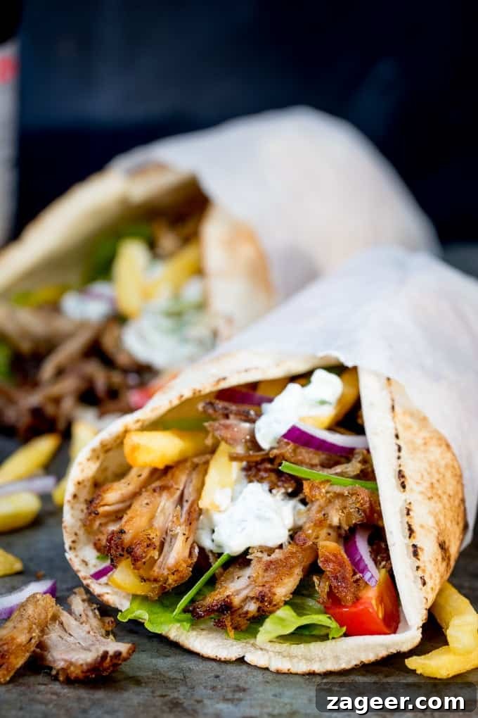 Crispy Pork Gyros Recipe: Greek-Style Sandwich with Tzatziki 6 Pork gyros on an open flatbread with lettuce, onion, tomato and tzatziki