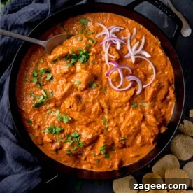 Leftover turkey curry in a skillet topped with coriander