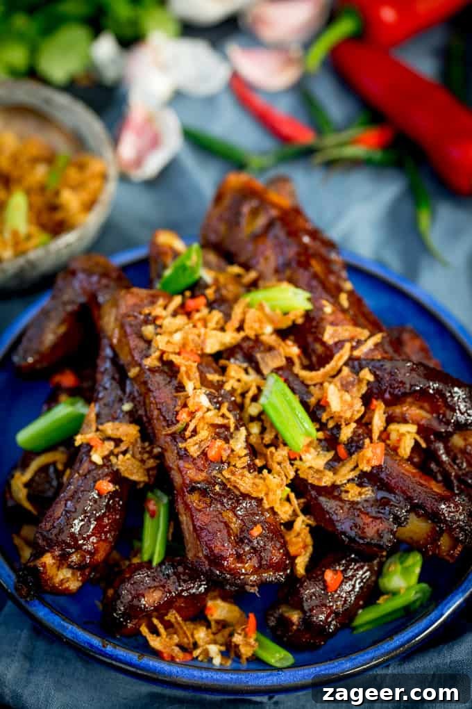 Crispy Onion Oven-Baked Asian Ribs Recipe 2 Oven Baked Asian Ribs with Crispy Onions on a blue plate