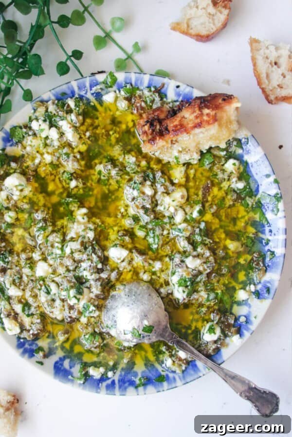 Jalapeno popper bread dipping oil on a blue and white patterned plate.