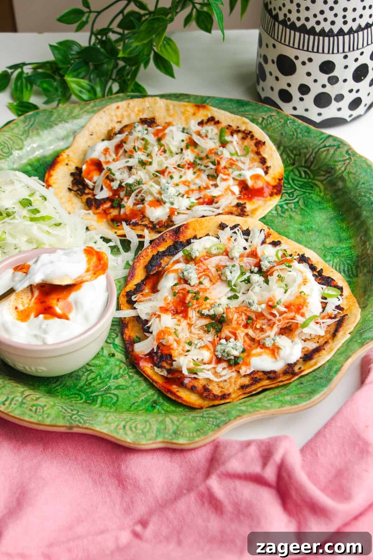 Buffalo chicken smash tacos on a serving platter.