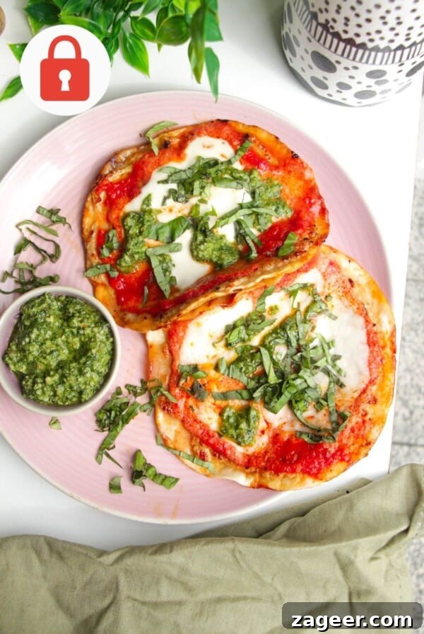 Chicken parm tacos on a platter with basil pesto.