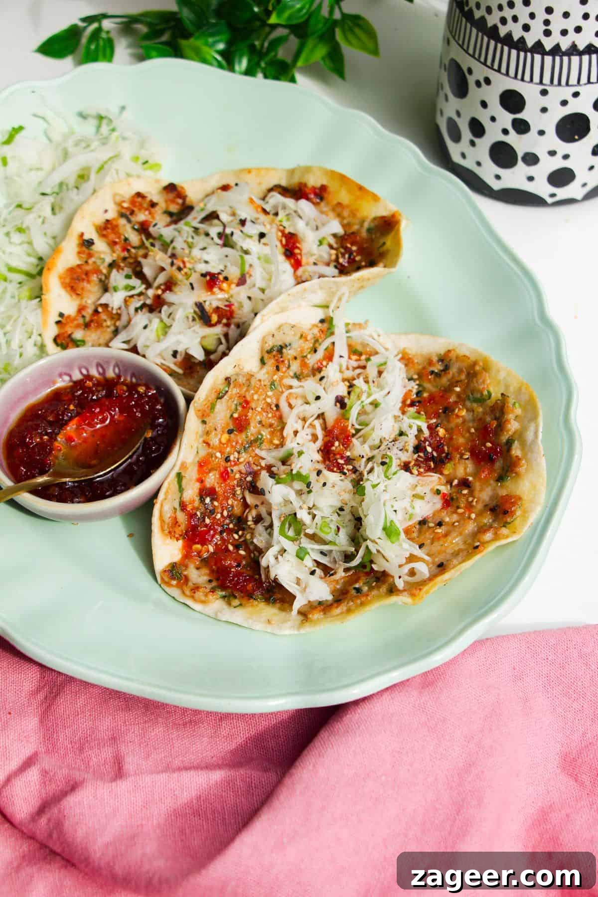 Two sweet chili chicken tacos on serving platter.