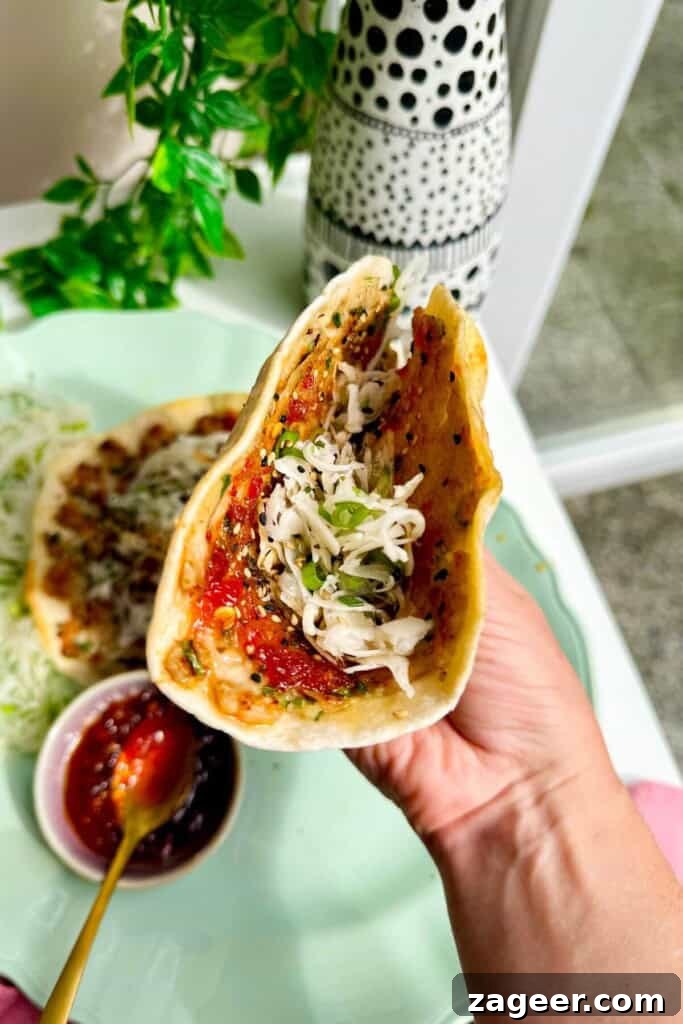 Holding sweet chili chicken taco.