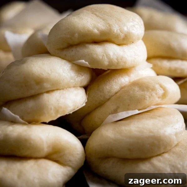 A close up of lots of bao buns piled up high