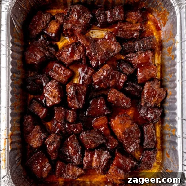Chunks of glazed Pork Belly Burnt Ends in a tray.
