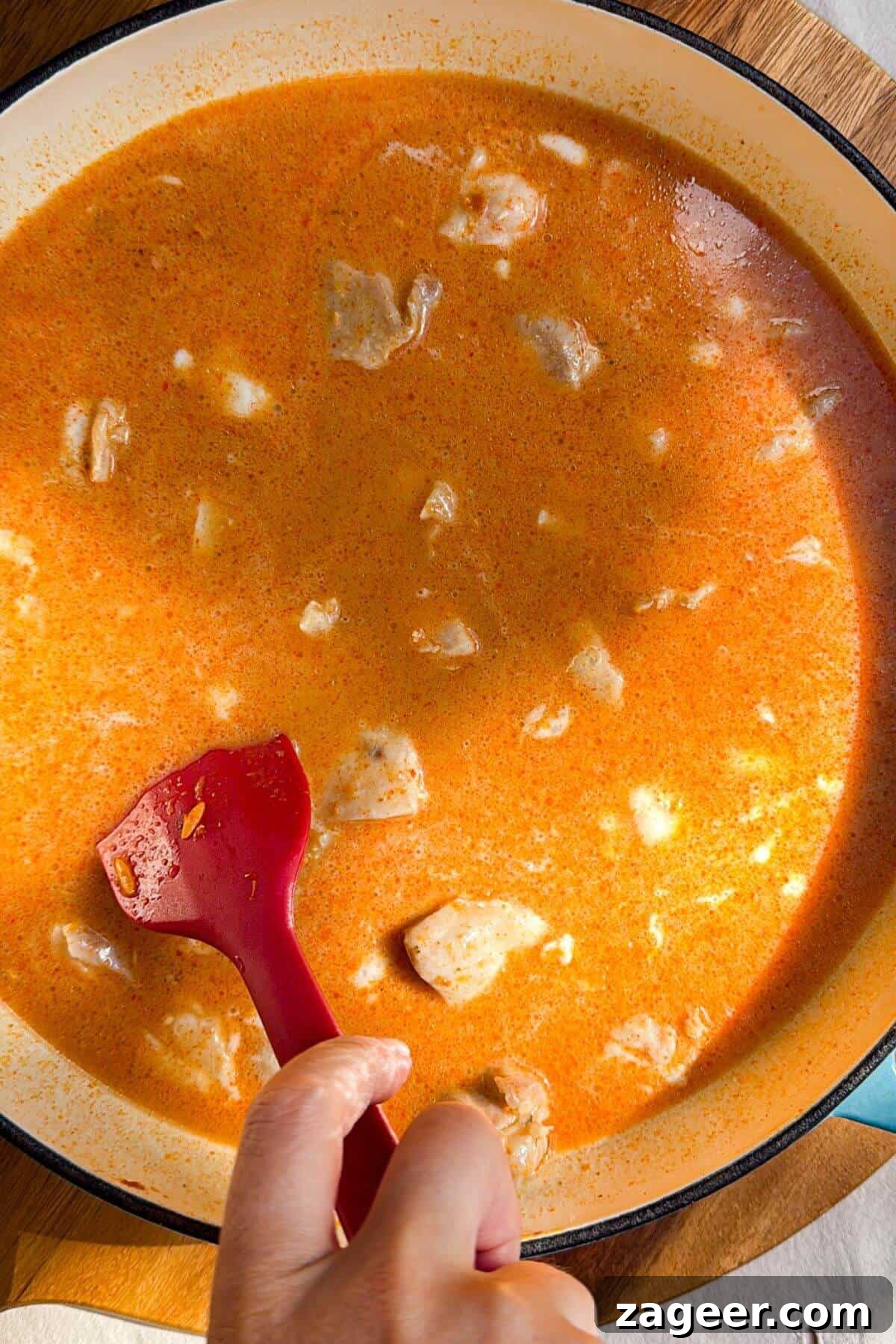 One-Pot Thai Red Curry Chicken Orzo for Weeknight Dinners 9 Stirring chicken through stock, coconut milk and orzo.